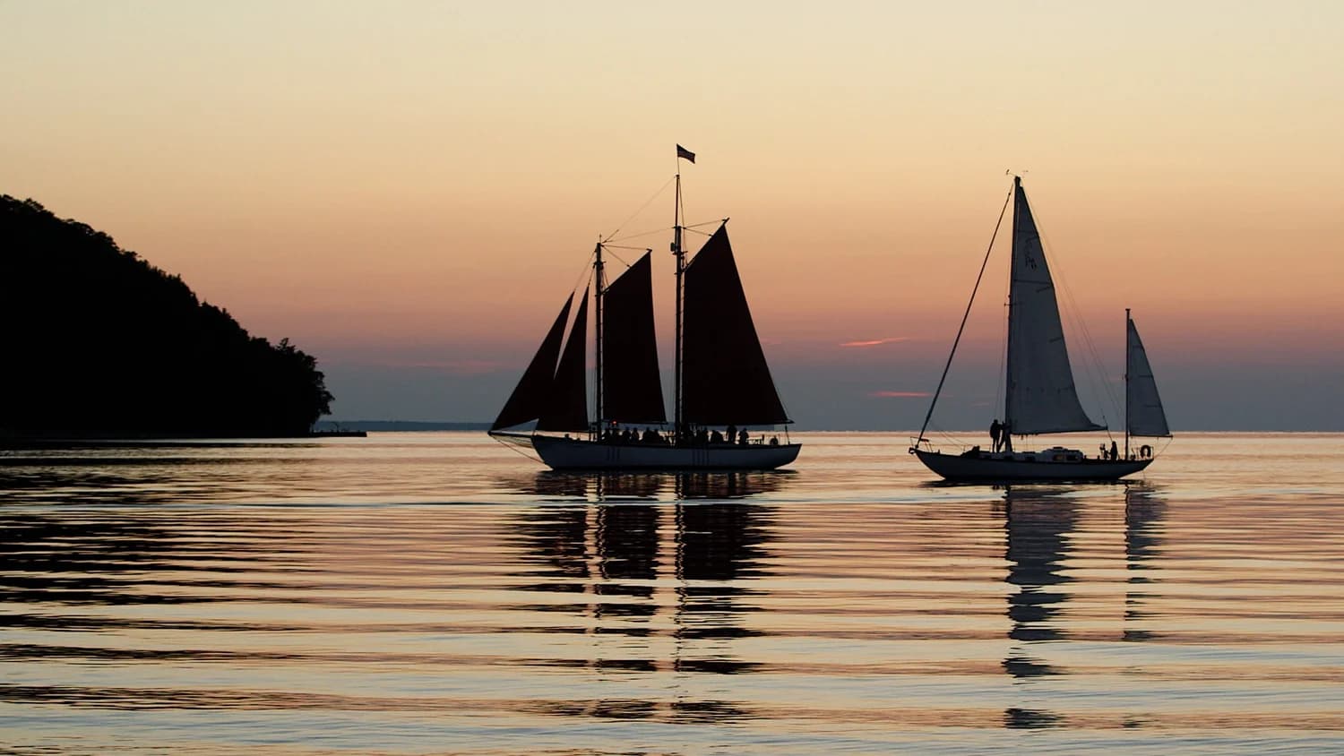 sailboats at sunset