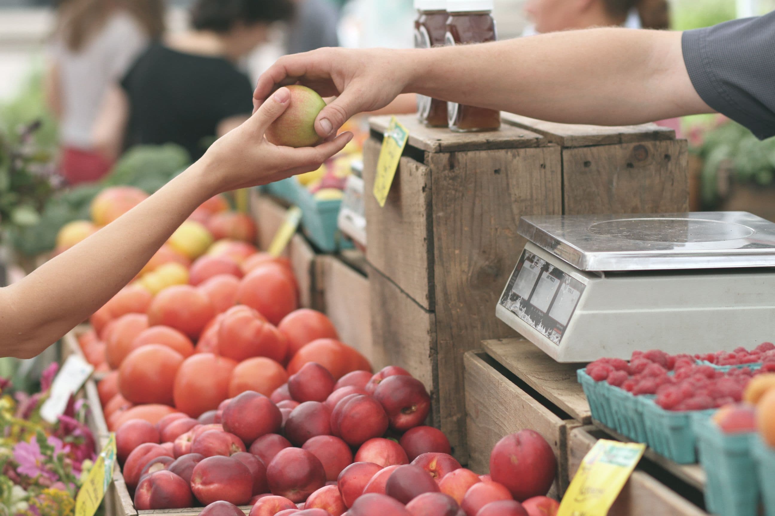 handing an apple across the counter