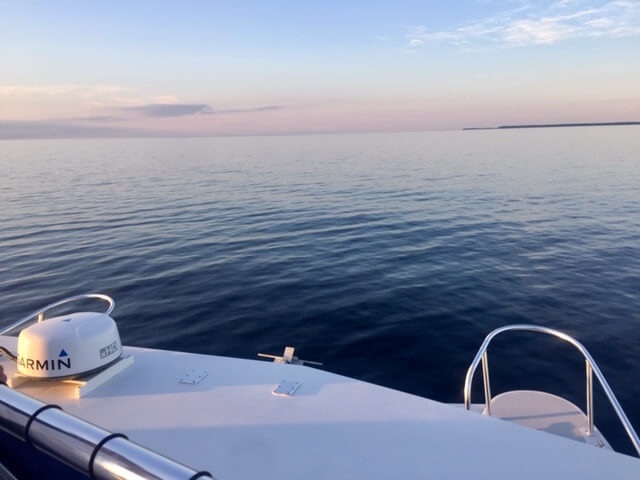 The start of the sunset over the bow of the tour boat.